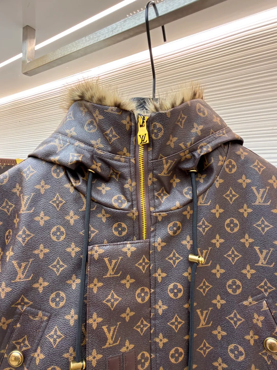 LOUIS VUITTON letter print hooded jacket ●Original version: Purchased and developed for 69999 ●Item number: 1681985-E40 ●Fabric: cotton fabric ●Technology: printing production ●Color: brown ●Version: fitted version ●Weight: about 1810 grams ●Size: 46-48-50-52 ●Description: This printed jacket is made of embossed leather fabric with a dark brown base and is fully printed with the classic Monogram pattern. The embossing process gives the logo a three-dimensional texture. The edge of the hood is spliced ​​with a natural fur collar, and the brim is equipped with an adjustable drawstring (metal rope buckle) to enhance warmth and style. The placket is double-closed with a two-way metal zipper and brass snap buttons. The zipper puller and snap button are both engraved with the brand logo, which is thick and durable. The body is designed with multiple pockets, and the pockets are edged with the same material + metal snap buttons for reinforcement. The left sleeve is equipped with a hidden adjustment tab. The interior is filled with high-fill down cotton, and the stitching adopts diamond-shaped quilting technology to prevent the filling from shifting. The seams are edged with leather of the same color, and the overall wiring is precise, taking into account warmth retention and luxurious texture. The overall wiring is straight and delicate, the fabric is comfortable and soft, and the color is consistent without color difference. It can be matched with the same style to create a fashionable look and control various occasions. Customized accessories, complete with three standards, same style for men and women!
